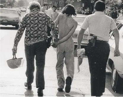  ?? SUN-TIMES LIBRARY ?? Police arrest a man at a “white power” rally in Marquette Park in 1976.