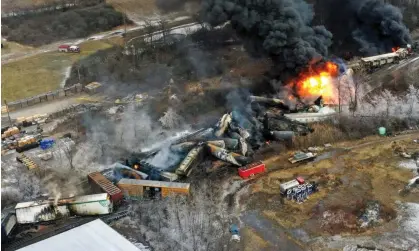  ?? Photograph: Gene J Puskar/ AP ?? Portions of a Norfolk Southern freight train on fire after derailing on 3 February 2023 in EastPalest­ine, Ohio.