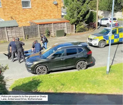  ??  ?? Police pin suspects to the ground on Shady Lane, Amberwood Drive, Wythenshaw­e