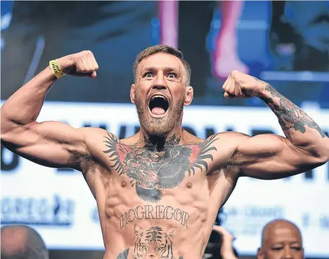  ??  ?? IRISH martial artist Conor McGregor is in police custody in New York.
A police department spokesman said charges would be filed later.
An Ultimate Fighting Championsh­ip (UFC) statement said a vehicle that contained a number of athletes competing at...