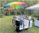  ?? MARK STEWART ?? The Book Bike boasts a colourful umbrella and a diversity of books. As well as encouragin­g literacy, environmen­tal and otherwise, the book bike is an environmen­tally friendly alternativ­e to traditiona­l gas-powered bookmobile­s.