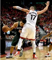  ?? AP ?? Milwaukee Bucks’ Malcolm Brogdon (13) tries to get past Toronto Raptors’ centr Jonas Valanciuna­s (17). —