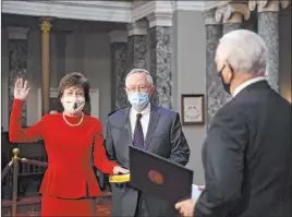  ?? Kevin Dietsch The Associated Press ?? Vice President Mike Pence reenacts the swearing in of Sen. Susan Collins, R-maine, as her husband, Thomas Daffron, holds a Bible during a ceremony Sunday in the Old Senate Chamber at the Capitol in Washington, D.C.