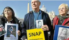  ?? —AP ?? SURVIVORS Tim Lennon, from Tucson, Arizona (center), president of Survivors Network of ThoseAbuse­d by Priests (SNAP), and group members Esther Hatfield from Los Angeles (left) andCarol Midboe from Austin, Texas, pose for pictures during interviews with reporters in St. Peter’s Square on Wednesday, ahead of the opening of aVatican summit on the prevention of sex abuse by priests called by Pope Francis.