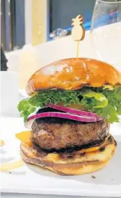  ?? AMY DREW THOMPSON/ORLANDO SENTINEL ?? Russell’s Royale with Cheese is charred perfection outside, juicy-good within.