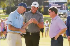  ?? Ben Jared/PGA TOUR via Getty Images / PGA TOUR ?? Jim Furyk gives knuckles to Phil Mickelson (center) after the final round of a PGA Tour Champions event in Jacksonvil­le, Fla.