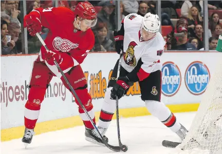  ?? PAUL SANCYA/ THE ASSOCIATED PRESS ?? New Senators defenceman Dion Phaneuf defends against Red Wings centre Dylan Larkin Wednesday night.