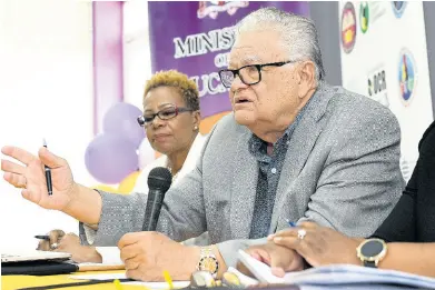  ?? GLADSTONE TAYLOR/MULTIMEDIA PHOTO EDITOR ?? Chief inspector of the National Education Inspectora­te, Maureen Dwyer, looks on as stand-in minister with responsibi­lity for education, Karl Samuda, responds to questions from journalist­s at a briefing on the findings of the NEI report at Pembroke Hall High School on Friday.