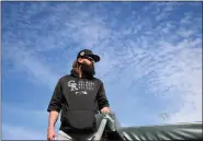  ?? RJ SANGOSTI — THE DENVER POST ?? Rockies right fielder Charlie Blackmon walks into the dugout before the start of a spring training Cactus League game at Salt River Fields at Talking Stick against the