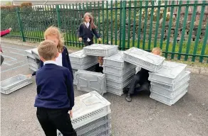  ??  ?? Pupils have already used the crates to create houses, tunnels and even skis and sledges in the school’s new play area.