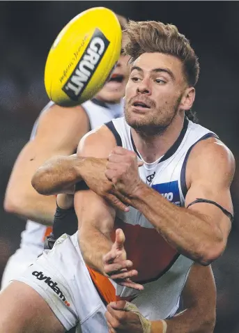  ?? Picture: AAP ?? HOW EASY WAS THAT: Stephen Coniglio of the Giants handpasses during yesterday’s lopsided encounter with Carlton at Etihad Stadium.