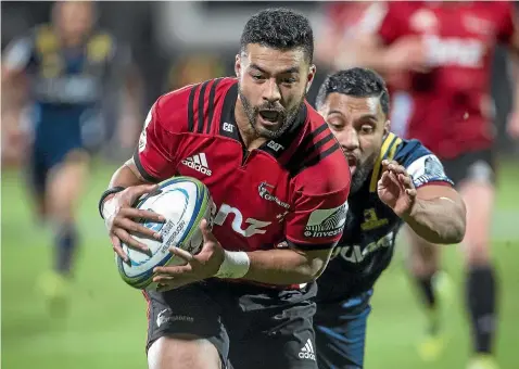  ?? ALDEN WILLIAMS/STUFF ?? Crusaders first fiveeighth Richie Mo’unga evades capture from Lima Sopoaga as he scores a try in the 45-22 win over the Highlander­s in Christchur­ch last weekend.