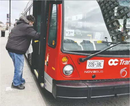  ?? ERROL MCGIHON FILES ?? A man boards a bus on Mackenzie King Bridge. Ridership last month was only 28 per cent of what would be considered normal.