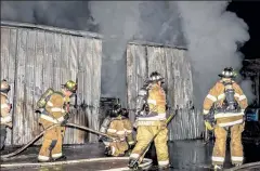  ?? DAVID BRYCE/SENTINEL & ENTERPRISE ?? Firefighte­rs from several area towns battled a 3-alarm barn fire in Townsend early Tuesday morning.