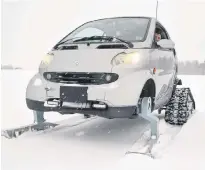  ?? ERIC MCCARTHY/JOURNAL PIONEER ?? Jarrett Martin shows off the Smart Car he’s converted into a wintertime Smart sled. The sight of the car powering through snow-covered fields has lots of people snapping photos.