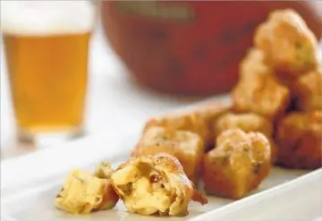  ?? Photog r aphs by Kirk McKoy
Los Angeles Times ?? POUR I N SOME BEER for f lavor and f izz. These beer- battered mac- and- cheese bites have some IPA f lavors.