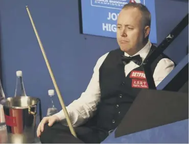  ??  ?? A pensive John Higgins surveys the scene at The Crucible during his semi-final with Kyren Wilson.