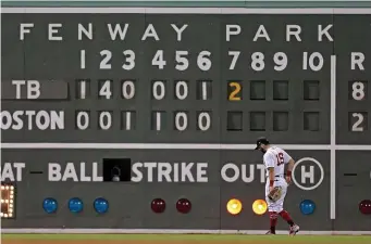  ?? MATT STONE / BOSTON HERALD ?? SAD STORY: Andrew Benintendi stands in front of the scoreboard during the Red Sox’ 8-5 loss to the Rays last night at Fenway Park.