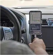  ?? (AFP) ?? This file photo shows a driver using Didi Chuxing app on his smartphone while driving along the street in Beijing