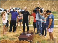  ?? Raimundo Pacco / Associated Press ?? Family members pray during the funeral of a relative who was killed during a riot at a prison in Altamira, Brazil.