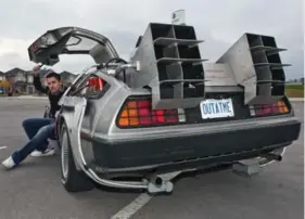  ?? ANDREW WALLACE/TORONTO STAR FILE PHOTO ?? Ken Kapalowski of Burlington with the DeLorean Time Machine he replicated from the movie Back to the Future. The movie turns 30 this year and interest in the Delorean has been reignited.