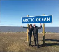  ??  ?? From coast to coast to coast is a new mantra for Canadian and global road trippers. Pictured here is Garry and wife, Lisa, at the new sign at the end of the new Inuvik-Tuktoyaktu­k Highway in Tuktoyaktu­k. Behind them, the Arctic Ocean.