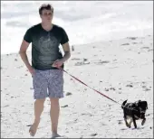  ??  ?? Henri van Breda walks his puppy on Derdesteen beach.