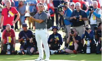  ?? Photo: AP ?? Francesco Molinari of Italy holds the trophy after winning the British Open Golf Championsh­ip