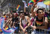 ?? AP PHOTOS ?? Spectators watch as revelers march down Fifth Avenue during the annual NYC Pride March on Sunday in New York.