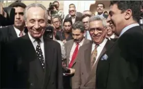  ?? THE ASSOCIATED PRESS FILE ?? Israeli Foreign Minister Shimon Peres, left, is all smiles along with PLO negotiator Mahmoud Abbas, second from right, and Egyptian Foreign Minister Amr Moussa, right, after talks in Cairo.