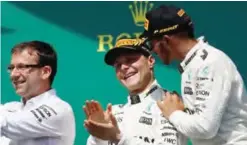  ??  ?? MONTREAL: Race winner Lewis Hamilton of Great Britain and Mercedes GP celebrates his win on the podium with second place finisher Valtteri Bottas of Finland and Mercedes GP during the Canadian Formula One Grand Prix at Circuit Gilles Villeneuve on...
