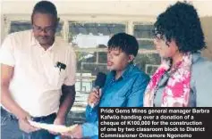  ?? ?? Pride Gems Mines general manager Barbra Kafwilo handing over a donation of a cheque of K100,000 for the constructi­on of one by two classroom block to District Commission­er Oncemore Ngonomo