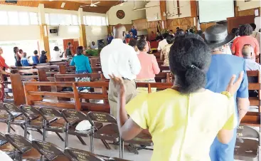  ?? RUDOLPH BROWN/PHOTOGRAPH­ER ?? Members worship at Covenant Moravian Church on Molynes Road, St Andrew, during yesterday’s service. The Moravian Church has been rocked by a sex scandal after one of its pastors, Rupert Clarke, was charged with having sex with a minor.