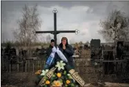  ?? EMILIO MORENATTI/ASSOCIATED PRESS ?? Galyna Bondar, mourns next to the grave of her son Oleksandr, 32, after burying him at the cemetery in Bucha, in the outskirts of Kyiv, Ukraine on Saturday, April 16, 2022. Oleksandr, who joined the territoria­l Ukrainian defence as a co-ordinator was killed by a gunshot by the Russian Army.