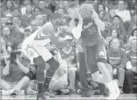  ?? THOMAS B. SHEA/ USA TODAY ?? Clippers forward Blake Griffin, right, is defended by Rockets forward Josh Smith in the first quarter Monday night in Houston. Griffin scored 26 points in the Clippers’ 117-101 victory.