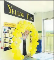  ?? ?? Our Yellow Flag Wall we created in our school.