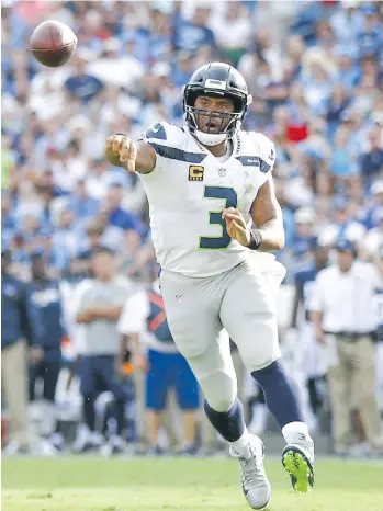  ?? SHABAN ATHUMAN/GETTY IMAGES ?? Seahawks quarterbac­k Russell Wilson makes a pass against the Tennessee Titans on Sunday. Seattle struggled to run the ball in its 33-27 loss, gaining 69 yards on 22 carries.