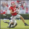  ?? Associated Press ?? Georgia quarterbac­k Stetson Bennett (13) scrambles away from Vanderbilt linebacker CJ Taylor (13) in the second half on Saturday in Athens, Ga.