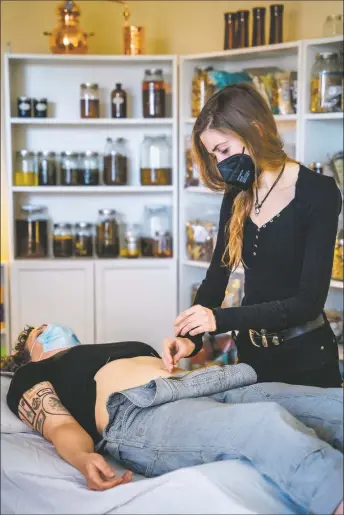  ?? NATHAN BURTON/Taos News ?? Dr. Clara Wetmore places acupunctur­e needles on patient Amy Dondanvill­e’s body on Wednesday (April 6). ‘I place needles at specific points along the relevant or affected meridians, based on symptoms, presentati­on and pulse diagnosis. Each point has unique indication­s, and I pick the points that relate to or address the symptoms and underlying health concerns,’ Wetmore explained.