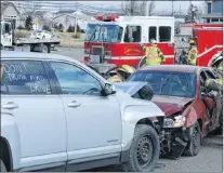  ?? JOE GIBBONS/THE TELEGRAM ?? With the message “Don’t drink and drive” wrote on the window of the mock car, firefighte­rs from the Goulds Volunteer Fire Department pretend to assess the situation as they deal with the severity of the injured victims in the car that was hit head-on...