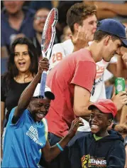  ?? MARK KOLBE / GETTY IMAGES ?? It might not be useful, but a young fan looks pleased after getting Dominic Thiem’s racket.