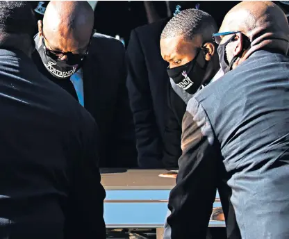  ??  ?? The casket with George Floyd is held with great care at the Fountain of Praise church in Houston, Texas, ahead of today’s funeral. Below, the final touches are made to a Black Lives Matter floral arrangemen­t at the church