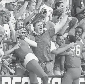  ?? BRETT COOMER/ AP ?? Sam Houston State fans celebrate the Bearkats’ 38- 35 semifinal win over James Madison.