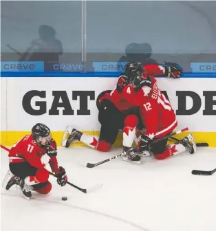  ?? GREG SOUTHAM ?? Dejected Team Canada players, from left, Cole Perfetti, Bowen Byram, Jakob Pelletier and Peyton Krebs drop to their knees after their once-in-a-lifetime world junior experience ended in monumental disappoint­ment. Canada dropped a 2-0 decision to the underdog Americans.