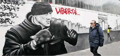  ?? AFP/AP ?? Ex-Boxprofi Christophe Dettinger griff Polizisten bei einer Demo an (oben) – ein Graffiti in Paris fordert seine Freilassun­g.