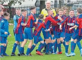  ??  ?? Dundee West (red/blue) celebrate their last-minute winner in their 3-2 U/14 Scottish Cup success against Fairmuir at Graham Street.