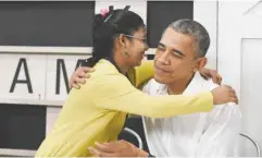  ??  ?? KUALA LUMPUR: US President Barack Obama gets a hug from a 16-year-old refugee from Myanmar after speaking about the refugee situation during a visit to the Dignity for Children Foundation yesterday. — AP