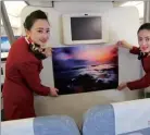  ?? BAO LIDA / FOR CHINA DAILY ?? Crew of Air China decorate passenger cabin wit local photo at a direct Chengdu-Colombo flight.