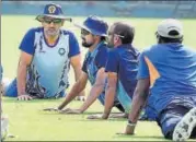  ?? PTI ?? Jharkhand captain M S Dhoni (left) with teammates during a training session at Eden Gardens.