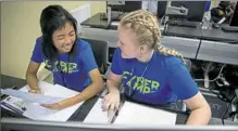  ?? Alex Driehaus/Post-Gazette ?? Eri Hayakawa of Upper St. Clair, left, and Martha Lacek of Pine-Richland, participat­e in a simulated cyberattac­k at the University of Pittsburgh's Cathedral of Learning.